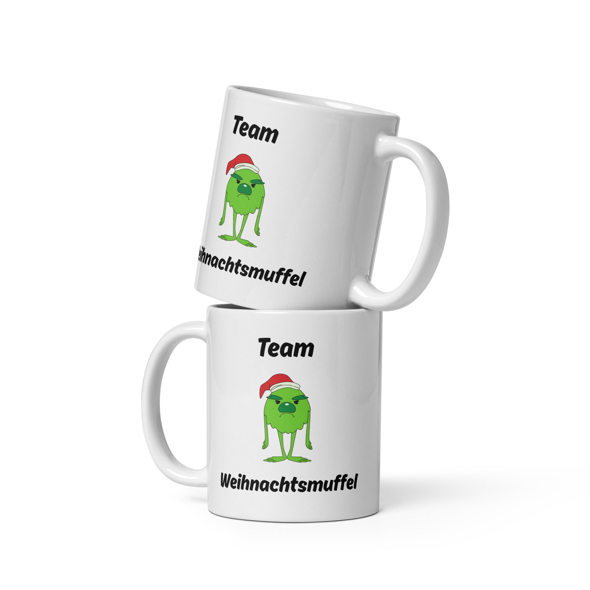 Weiße Tasse mit dem Spruch "Team Weihnachtsmuffel" und einem Bild eines grünen, traurig schauendem Monster mit Weihnachtsmütze in der Mitte