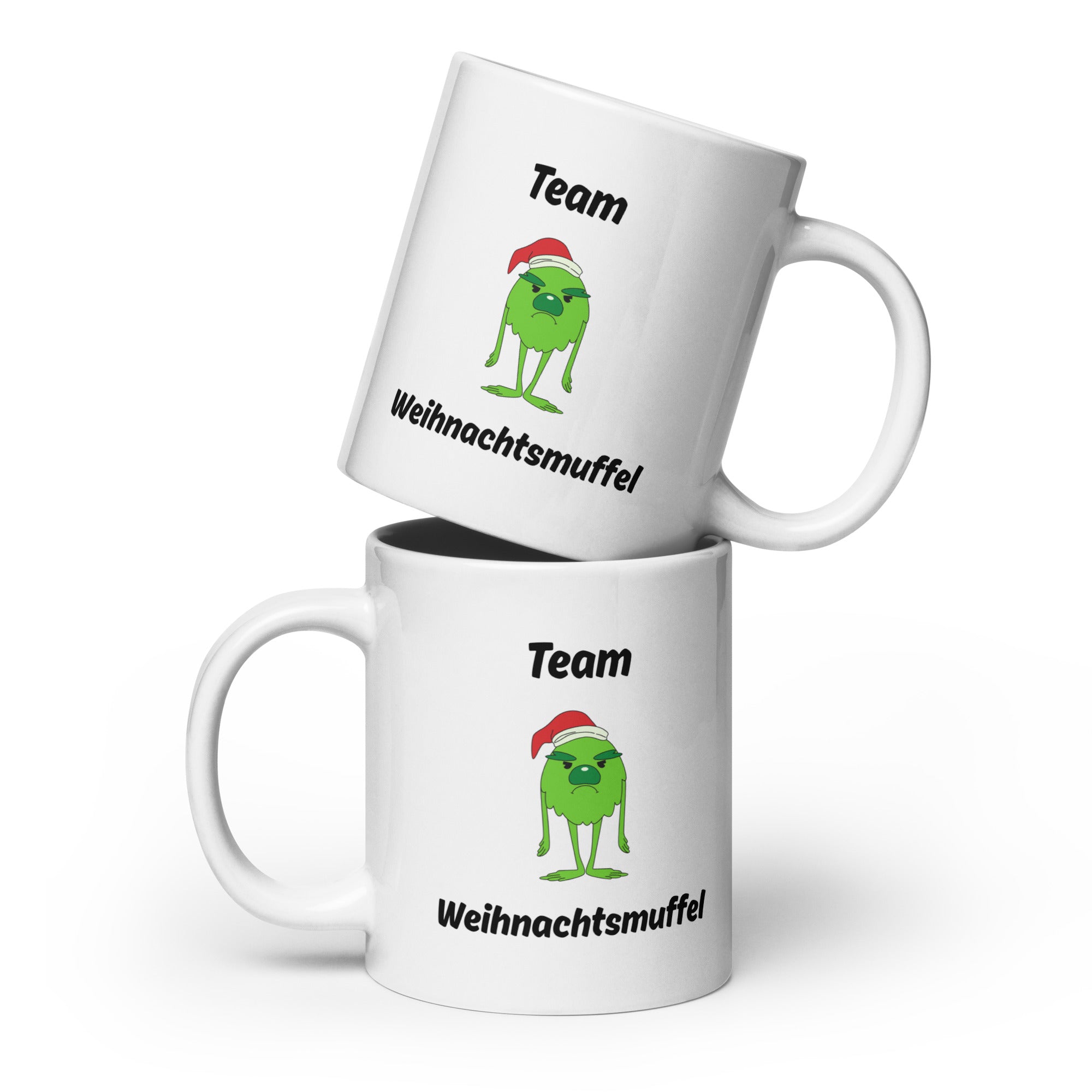 Weiße Tasse mit dem Spruch "Team Weihnachtsmuffel" und einem Bild eines grünen, traurig schauendem Monster mit Weihnachtsmütze in der Mitte